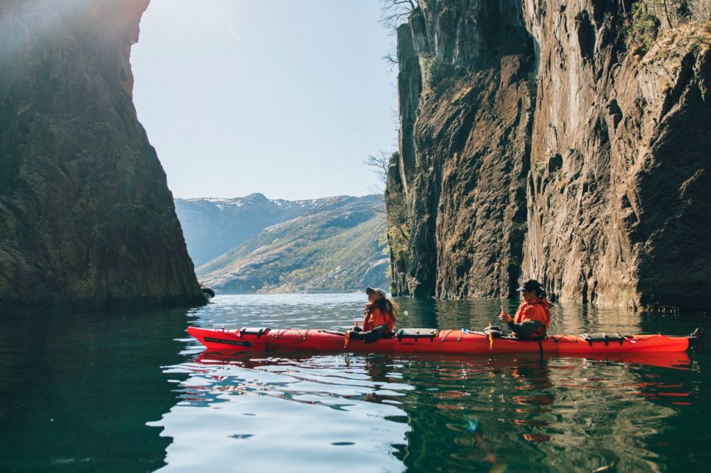 Two friends with kajakk on the fjord.